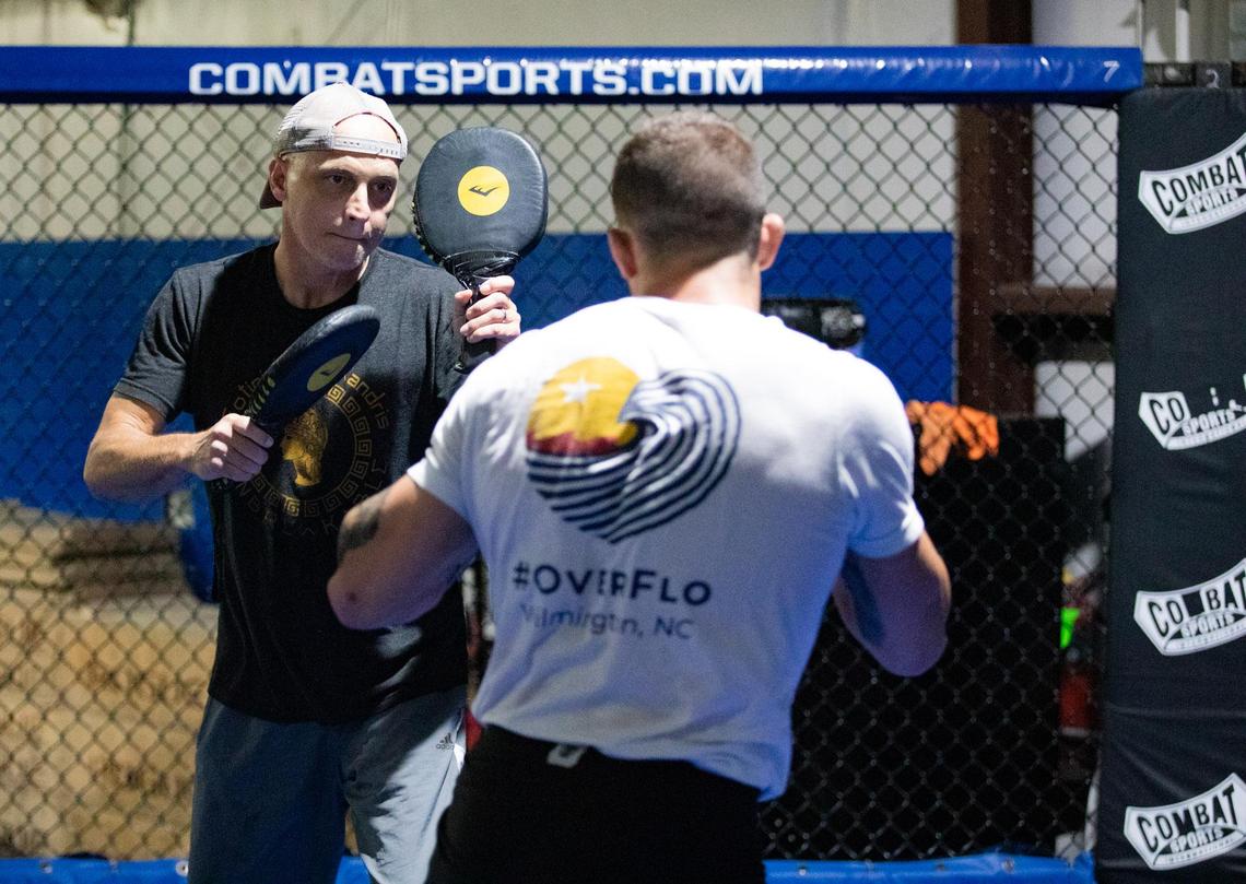 Trainer Chris Goude works with his fighter, Joe Solecki, Tuesday afternoon at Fitness Edge in Conway.