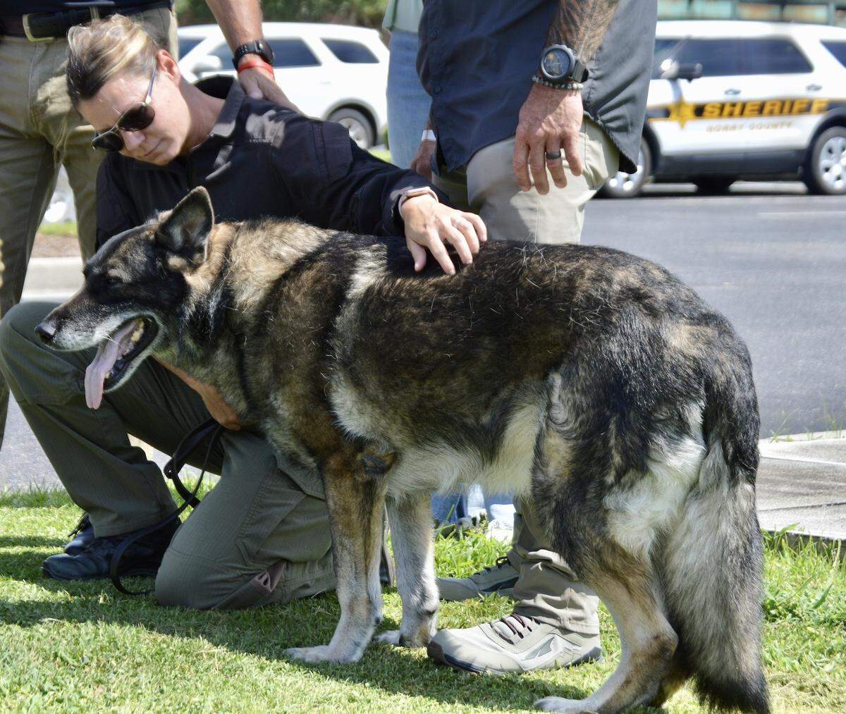 Officer Kane and Cpl. Misty Puckett in prayer before Kane’s escort to Murrells Inlet Veterinary Hospital
