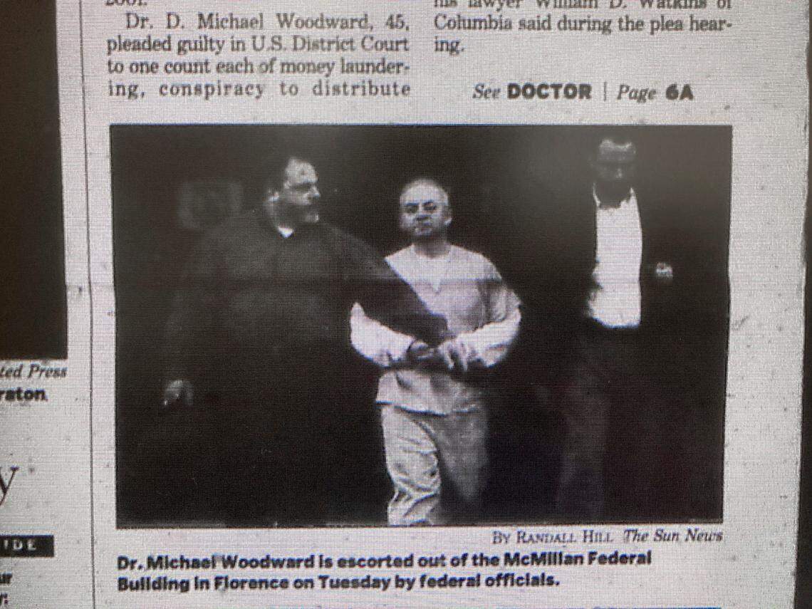 Dr. David Michael Woodward, former owner of Comprehensive Care and Pain Management Center in Myrtle Beach, is led out of the McMillan Federal Building in Florence in this Sun News clipping from January 8, 2003.