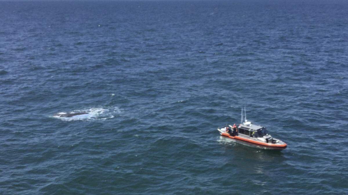 The Coast Guard rescued five fishermen from a capsized boat six miles off Pawleys Island.