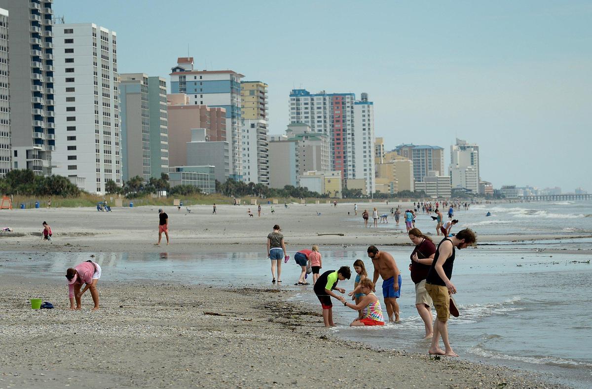 Beachgoers search for seashells along Springmaid Beach in the southern end of Myrtle Beach, SC following Hurricane Dorian on Friday, September 6, 2019.