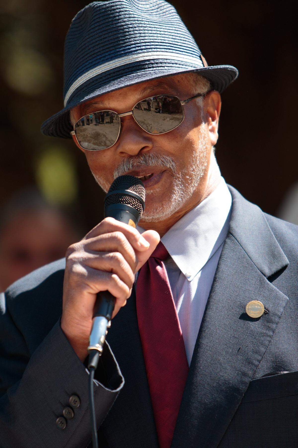 Herbert Riley, Jr. welcomes everyone to the ceremony. Residents and city officials meet beneath the shade of a huge cedar tree on the front lawn to remember Charlie’s Place on Carver St. in downtown Myrtle Beach. The City has purchased the property and plans to begin demolition later this week.