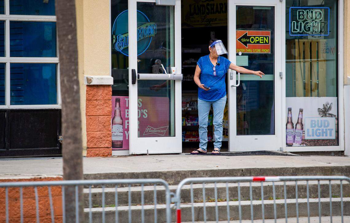 A woman wearing a facemask tosses a cigarette along Ocean Boulevard Wednesday afternoon in Myrtle Beach amidst the coronavirus pandemic.