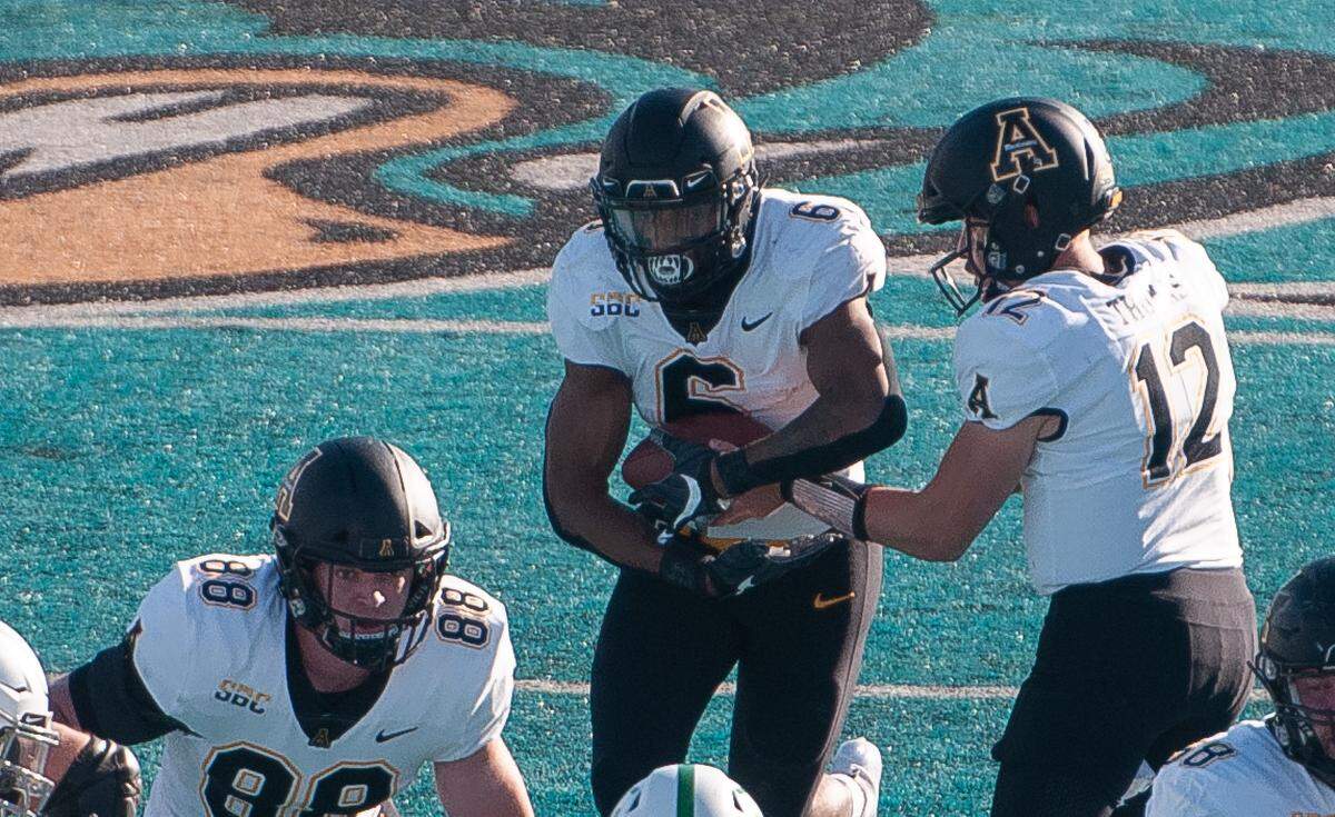 Appalachian State running back Camerun Peoples (6) takes a handoff from Zac Thomas (12) during App State’s 56-28 win over North Texas in the inaugural Myrtle Beach Bowl at Brooks Stadium in Conway. Dec. 21, 2020.
