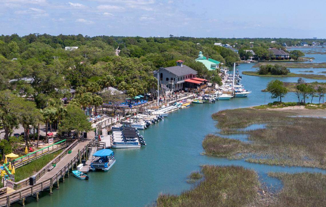 Aerial image of the Murrells Inlet community and Marshwalk. The water front is lined with seafood restaurants and entertainment options. Wednesday, April 24, 2024.