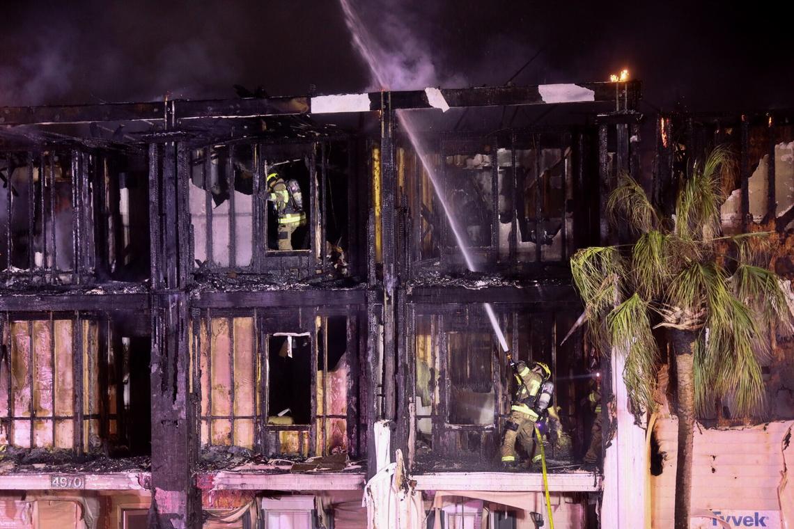 Firefighters fight a 4-alarm fire at the Windsor Green apartments Thursday night. One building was destroyed and six people were taken to the hospital with injuries.