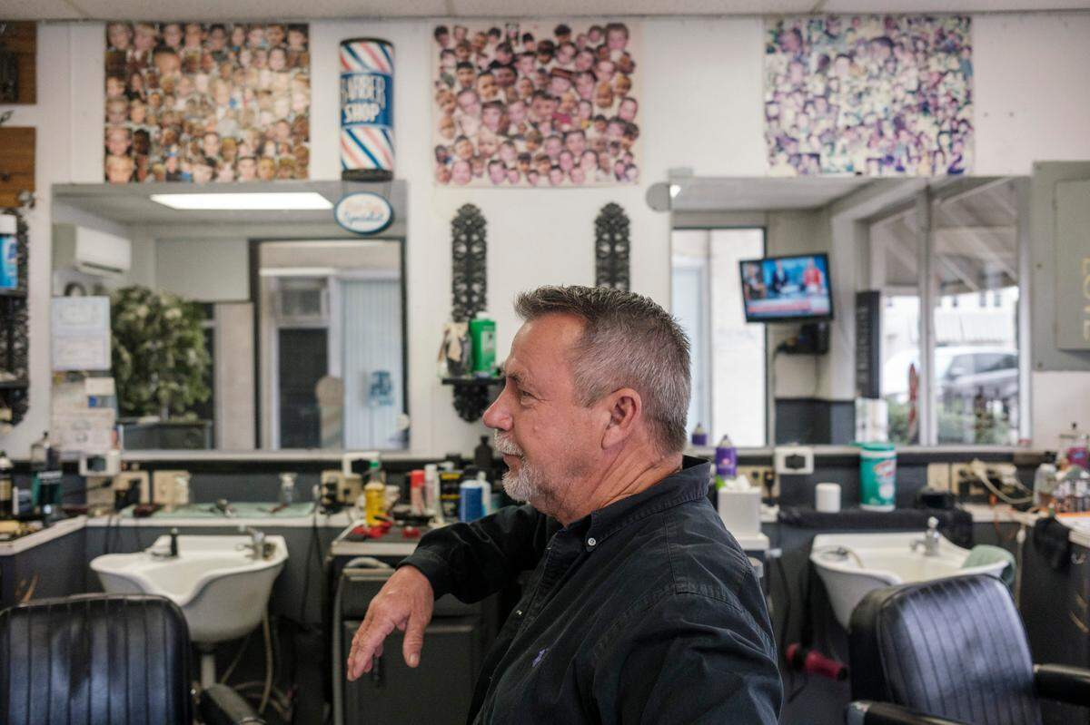 Woody Elvis opened Woody’s Barber shop and has been in the same location since 1971 in downtown Myrtle Beach. Elvis said he is now cutting hair for his fourth generation of customers and has many of those children’s pictures on the wall of his shop. October 11, 2023.