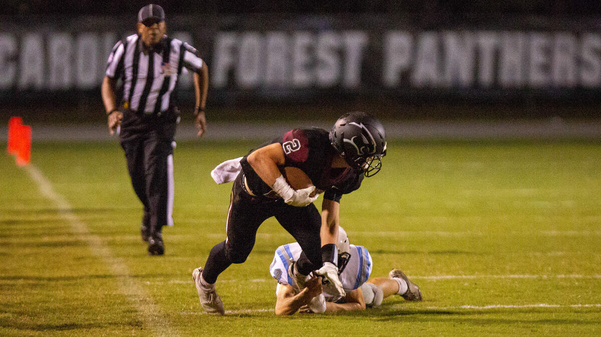 Carolina Forest senior receiver Jackson Weatherwax catches a pass against the St. James Sharks Friday night.