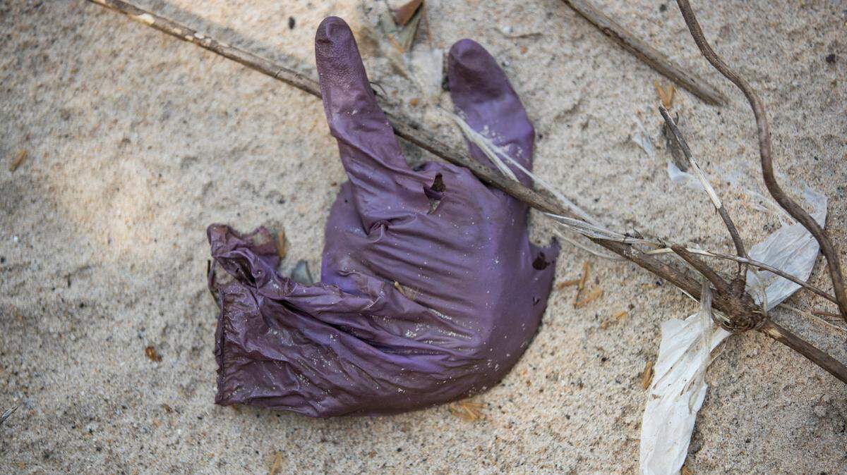A protective glove on the bank of a creek near Olympia Park in Columbia, South Carolina on Friday, March 12, 2021. Gloves and faces masks are an increasing litter concern.