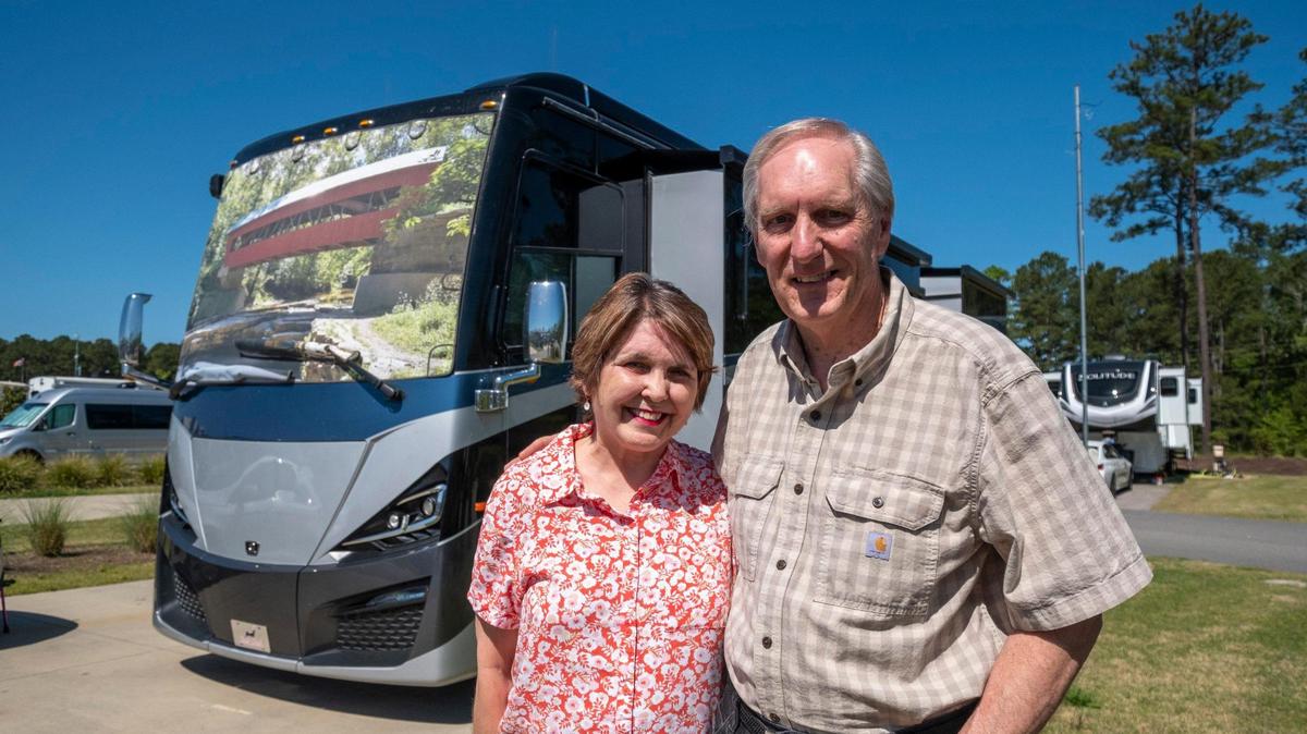 A shade on the front window of Joel Allen and Deanna Cochran’s 40-foot motor home displays a picture Allen made of a covered bridge while visiting Ohio. The couple, currently visiting Carolina Pines RV Resort, have made the RV their permanent home, traveling around the country in their vehicle with Cochran working remotely as Allen drives. April 18, 2023.