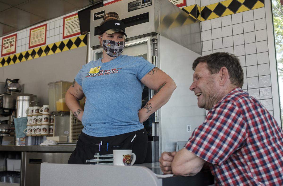 Jessica Fipps talks to one of her regular customers after returning to work at the Waffle House.”That was the exciting thing at five-thirty this morning when I woke up. Hey, I’m coming back to work now,” she said. “A lot of stress has been relieved.”May 29, 2020