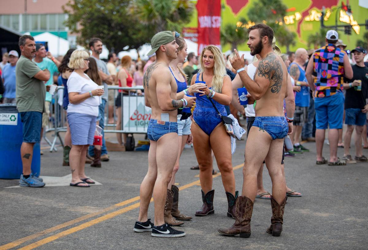 CCMF attendees dressed in all denim gather in the VIP area Thursday afternoon on the first day of Carolina Country Music Fest.