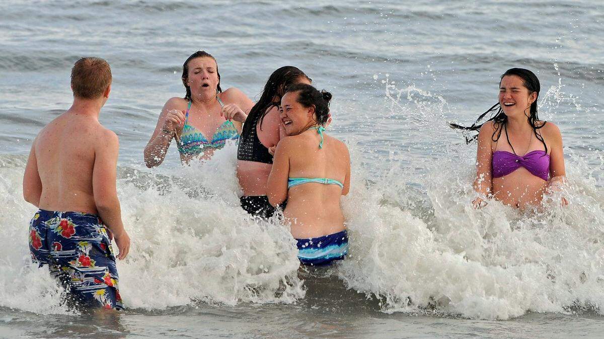 The area around Ocean Boulevard and the former Pavilion site was busy with people moving around on foot, scooters, motorcycles and cars, Thursday evening as the busy Easter weekend cranks up. Many were also braving the still cool waters of the Atlantic Ocean to play in the waves.