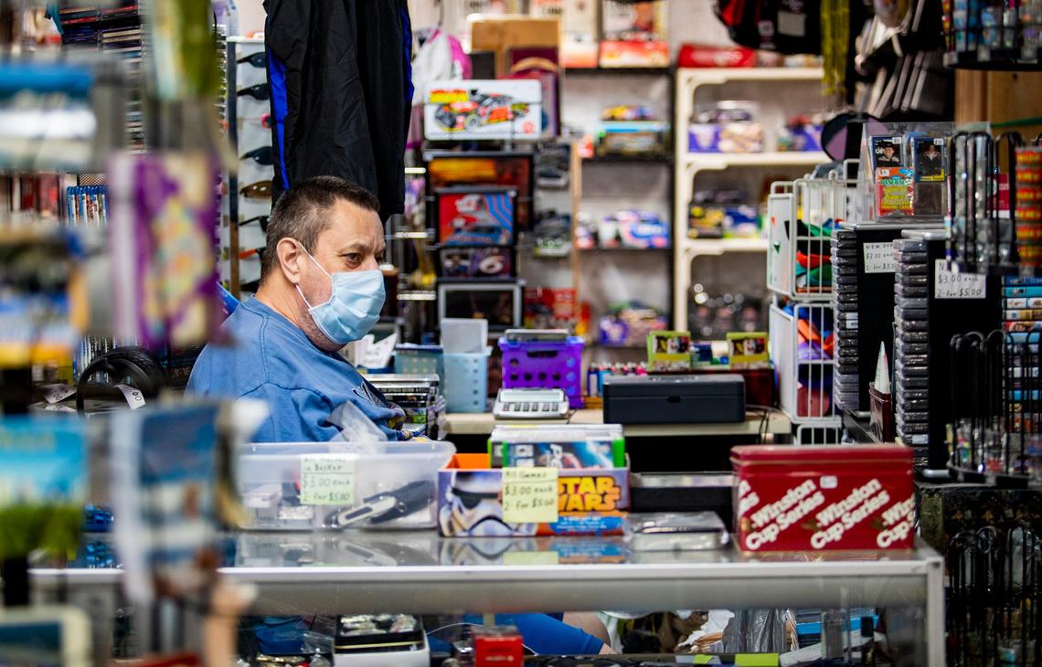 Hudson’s Flea Market vendor Mark Acord sits in his booth Thursday morning while waiting for customers. The flea market re-opened Thursday after shutting its doors for more than a month due to the COVID-19 coronavirus pandemic.