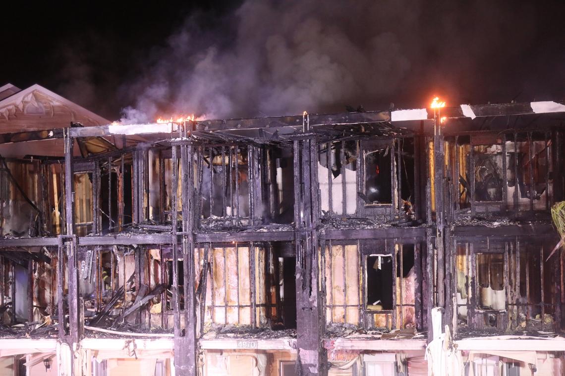 Firefighters fight a 4-alarm fire at the Windsor Green apartments Thursday night. One building was destroyed and six people were taken to the hospital with injuries.