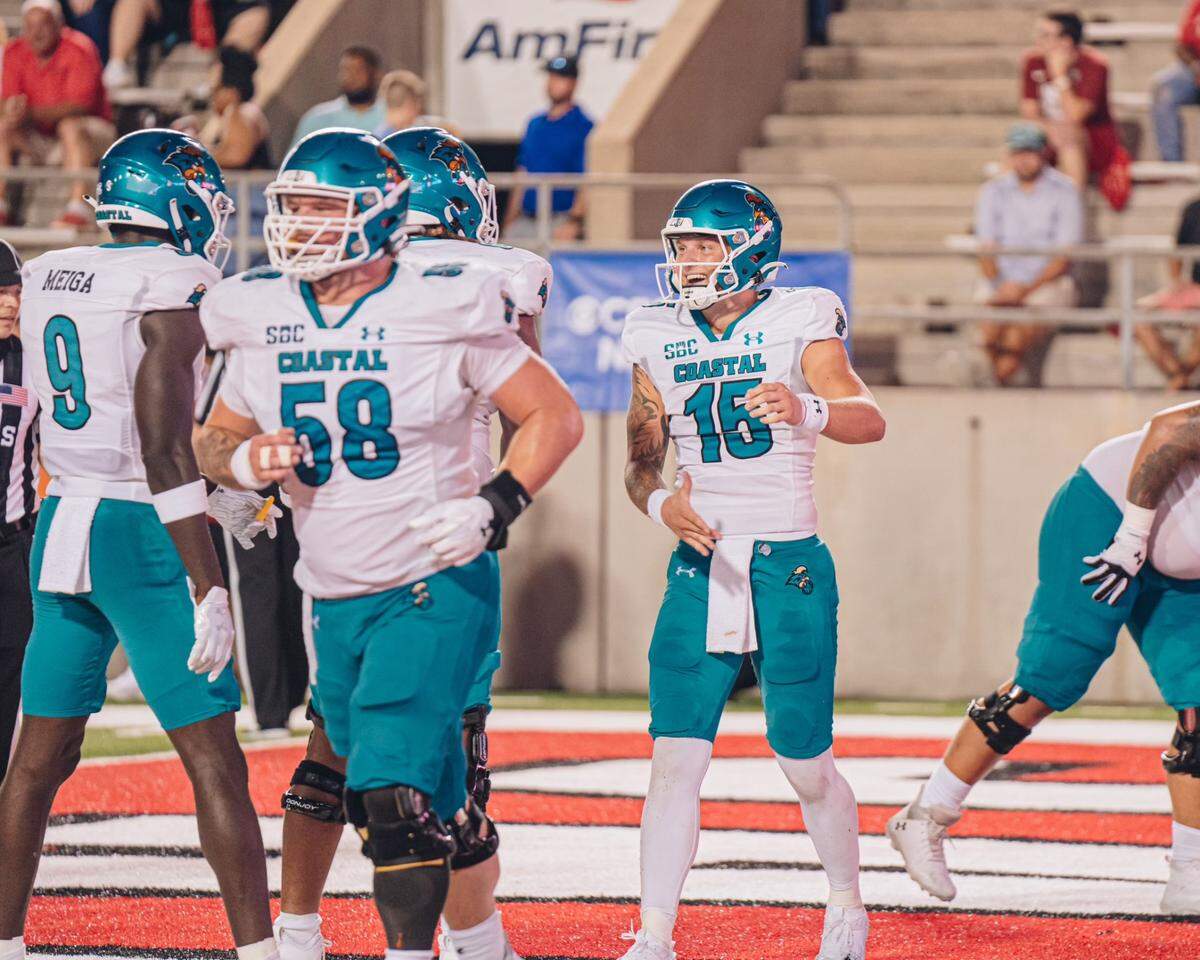 Coastal Carolina quarterback Ethan Vasko celebrates with teammates. The second-year Chant passer scored three touchdowns in CCU’s destruction of Jacksonville State 55-27 in Jacksonville, Ala.