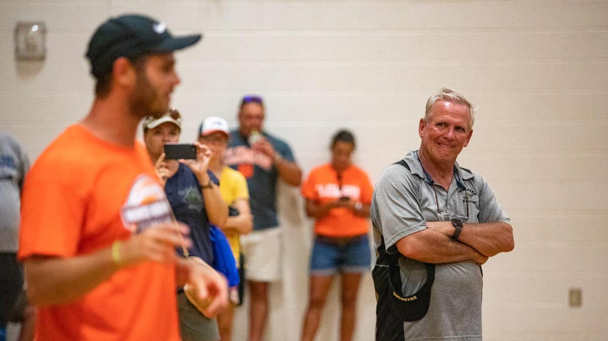 Socastee High School Athletic Director Tim Renfrow looks on as his son, Oakland Raiders wide receiver Hunter Renfrow, speaks to children in the gym at Socastee High School during his first-ever football camp after signs of lightning in the area Monday afternoon forced the camp indoors.