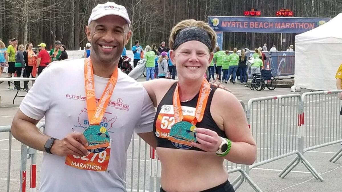 Yasir Salem (left) with friend Vicki Dufner after completing the 22nd Myrtle Beach Marathon on Saturday.
