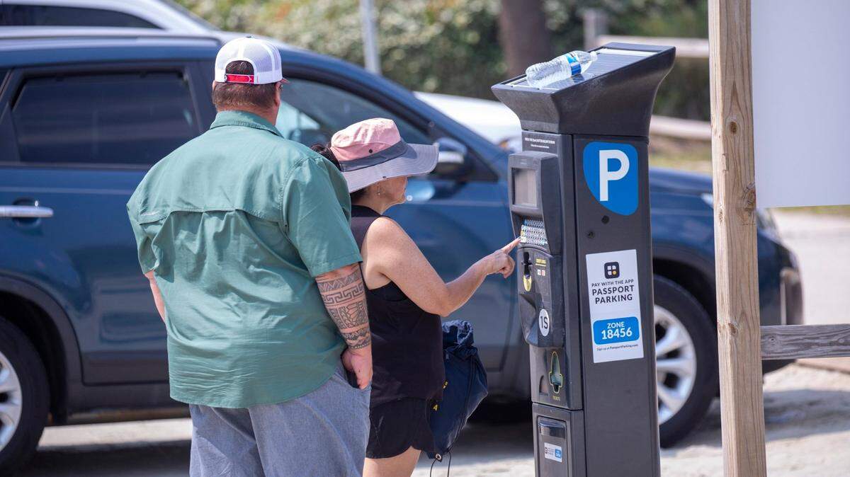 Beach visitors pay for parking in North Myrtle Beach, S.C. June 9, 2023. Residents of Grand Strand cities can get free parking if they apply for resident parking.