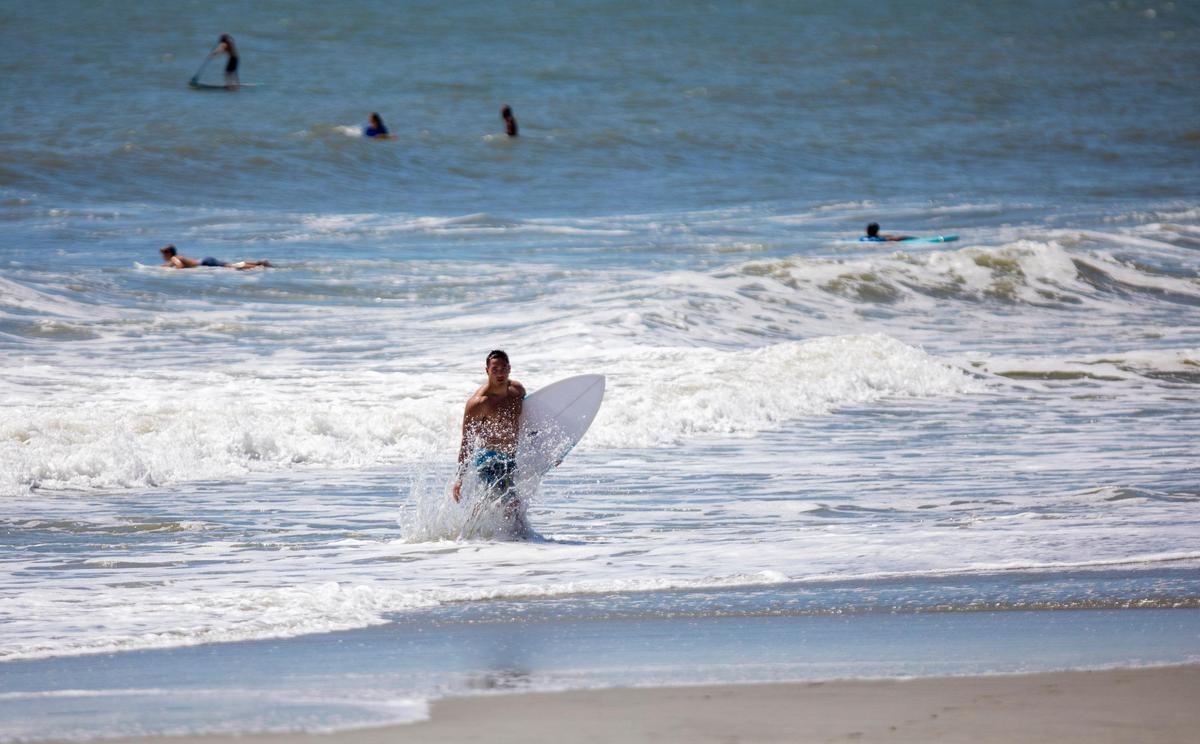 Surfers take to the waves off of 65th Ave. N. in Myrtle Beach Tuesday afternoon as Hurricane Dorian approaches.