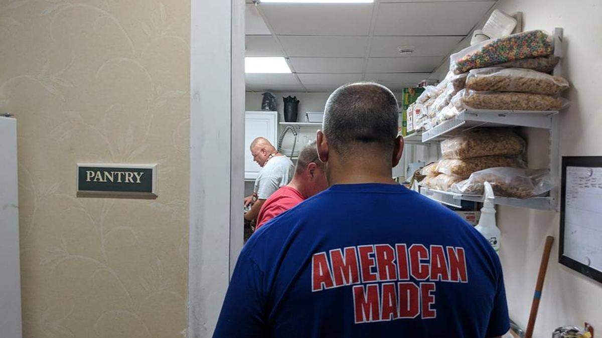 Shawn Hanna enters a small kitchen where food was prepared to serve hundreds of people.