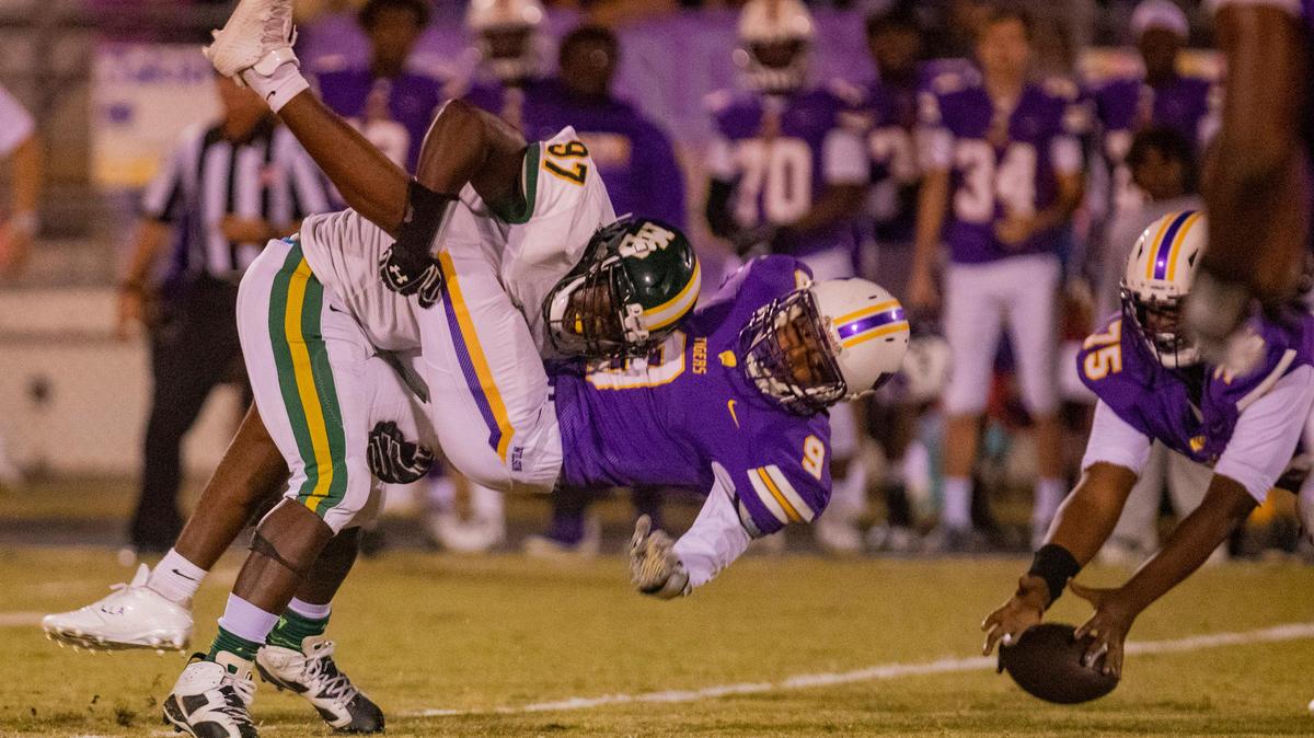 Myrtle Beach junior defensive tackle Shamarrell Walker tackles Wilson senior receiver Ji’travious Sherrills Thursday night at Florence Memorial Stadium in Florence.