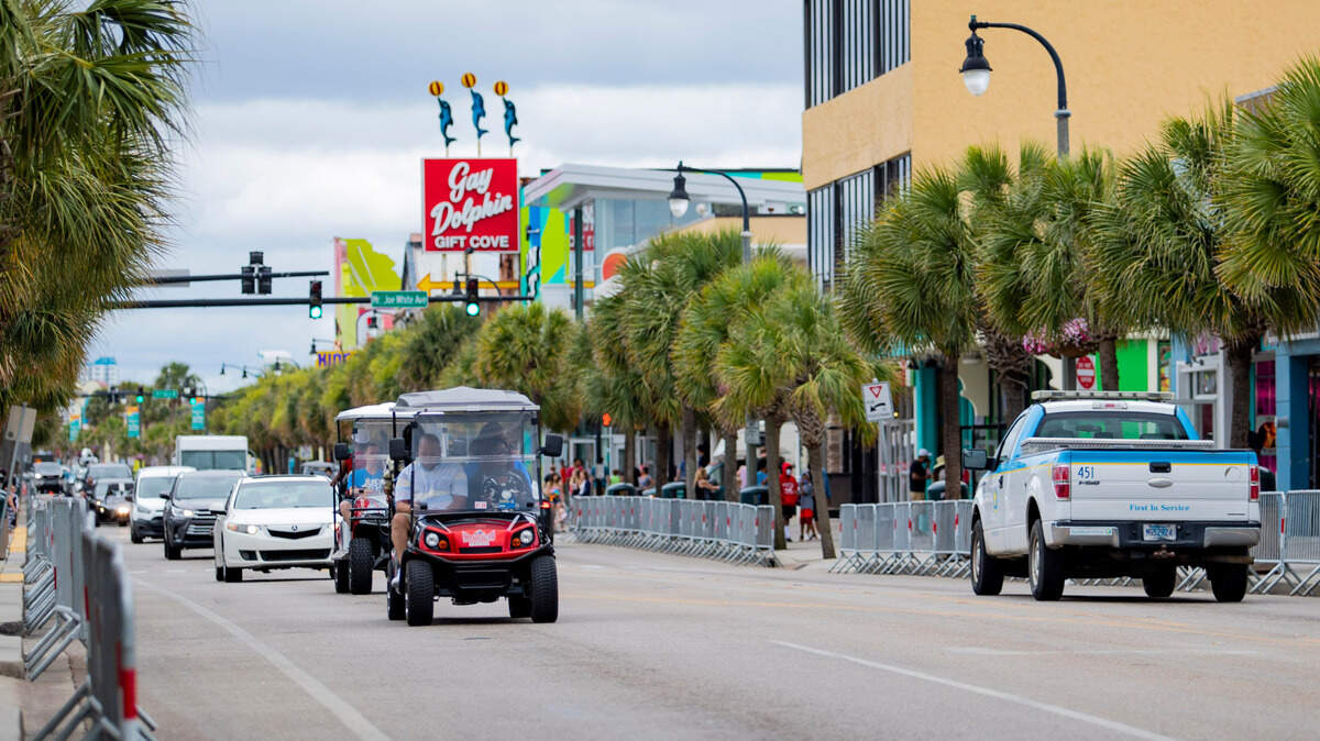 Golf carts drive along Ocean Boulevard in Myrtle Beach.