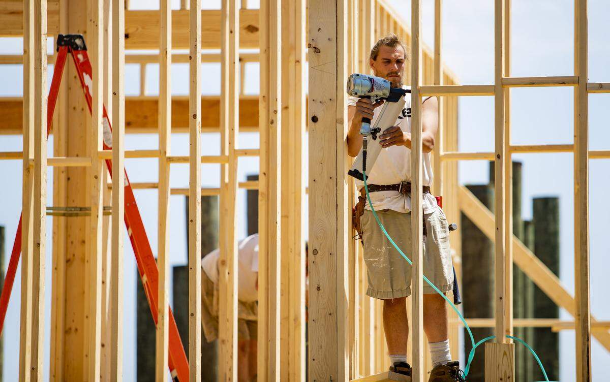 Cade Bruner of B & B Construction operates a nail gun on a home construction along Ocean Boulevard on April 9 in Myrtle Beach as Horry County continues to see a rise in COVID-19 coronavirus cases.