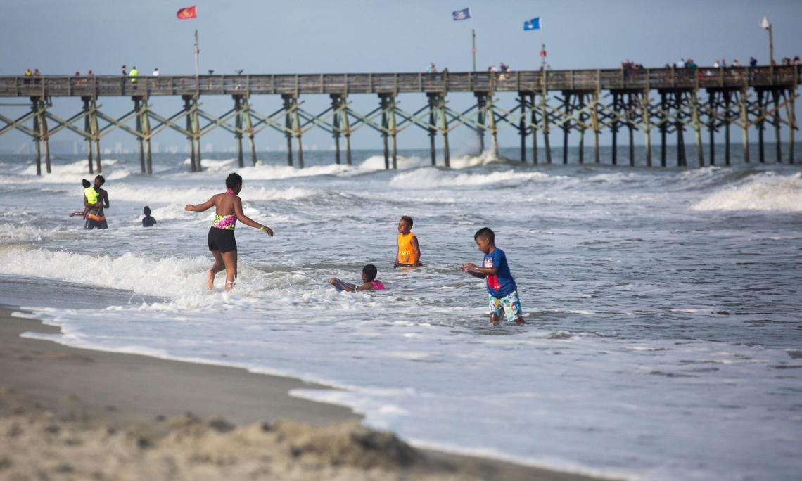 Beachgoers play in the ocean off of 10th Avenue North in Myrtle Beach, S.C. On Tuesday, May 29 the Department of Health and Environmental Control issued a swimming advisory for Horry County due to heightened bacteria levels in the ocean caused by the amount of rainfall associated with Tropical Storm Alberta.