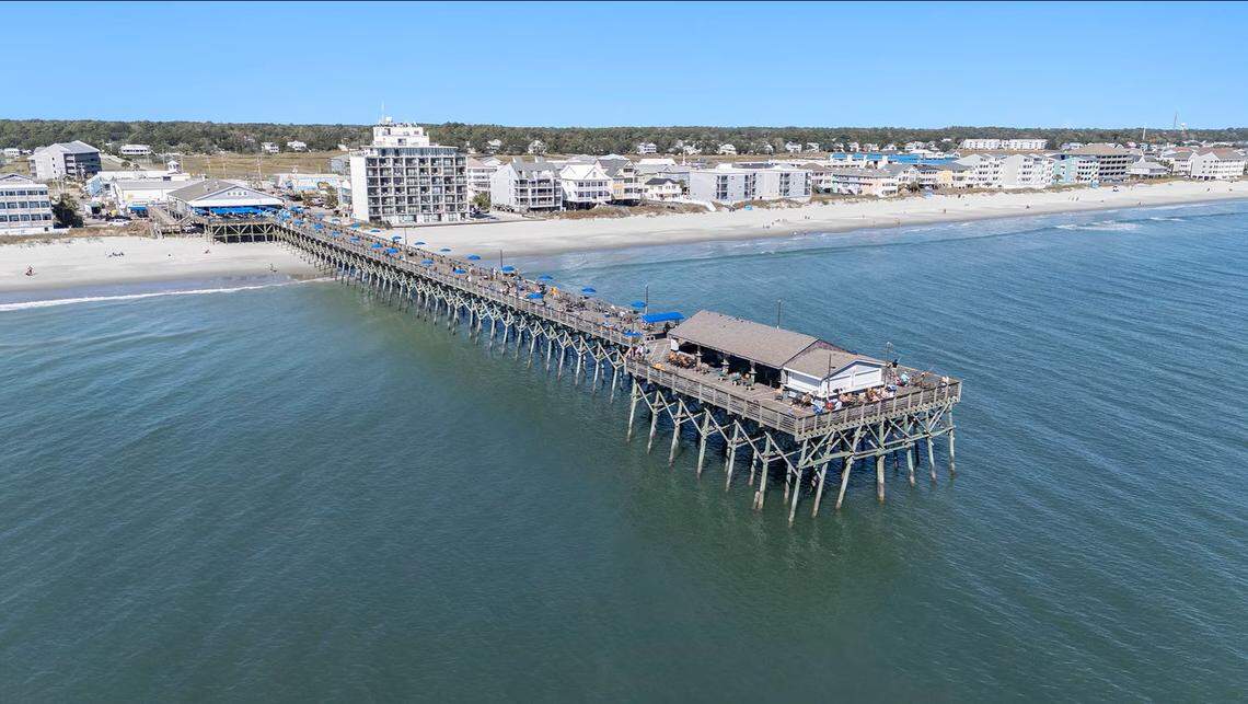 A screenshot from the LoopNet listing shows an aerial view of the Pier at Garden City over the Atlantic Ocean.