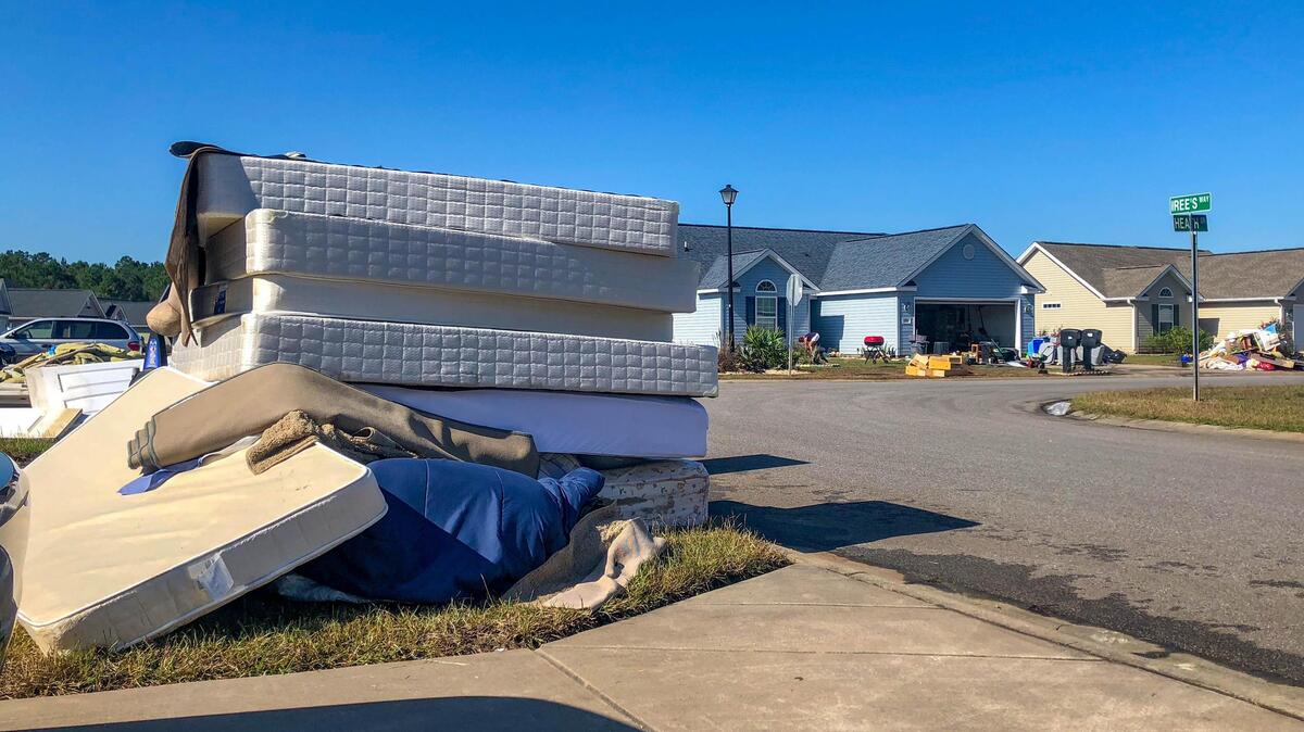 Front yards can be seen littered with carpet, Sheetrock and mattresses Monday as Polo Hills residents begin the arduous task of restoring their homes after the storm.