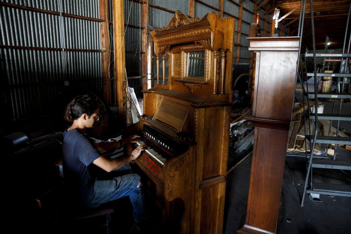 Gabe Brawner plays the “Haunted Mansion” theme song on an organ in the warehouse of Little Spider Creations in Loris. The business does large scale theming. The artistic, often spooky sculptures have been used in major theme parks and in television and movie productions. Sept. 19, 2024.