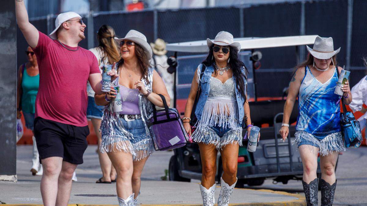 Country music fans arrive for the first night Carolina Country Music Fest 2024. The four day event is expected to draw 30,000 each night at the Burroughs and Chapin Pavilion Place in Myrtle Beach, S.C. Thursday, June 6, 2024.