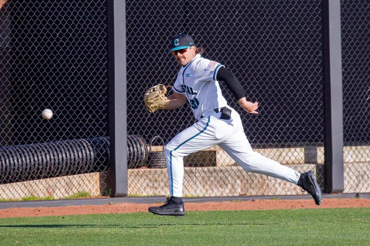 Coastal Carolina’s Tyler Johnson chases down a Kent State base hit in left field. CCU hosted Kent State during the Baseball at the Beach Tournament at Spring Brooks Stadium in Conway on Friday afternoon. February 18, 2022.
