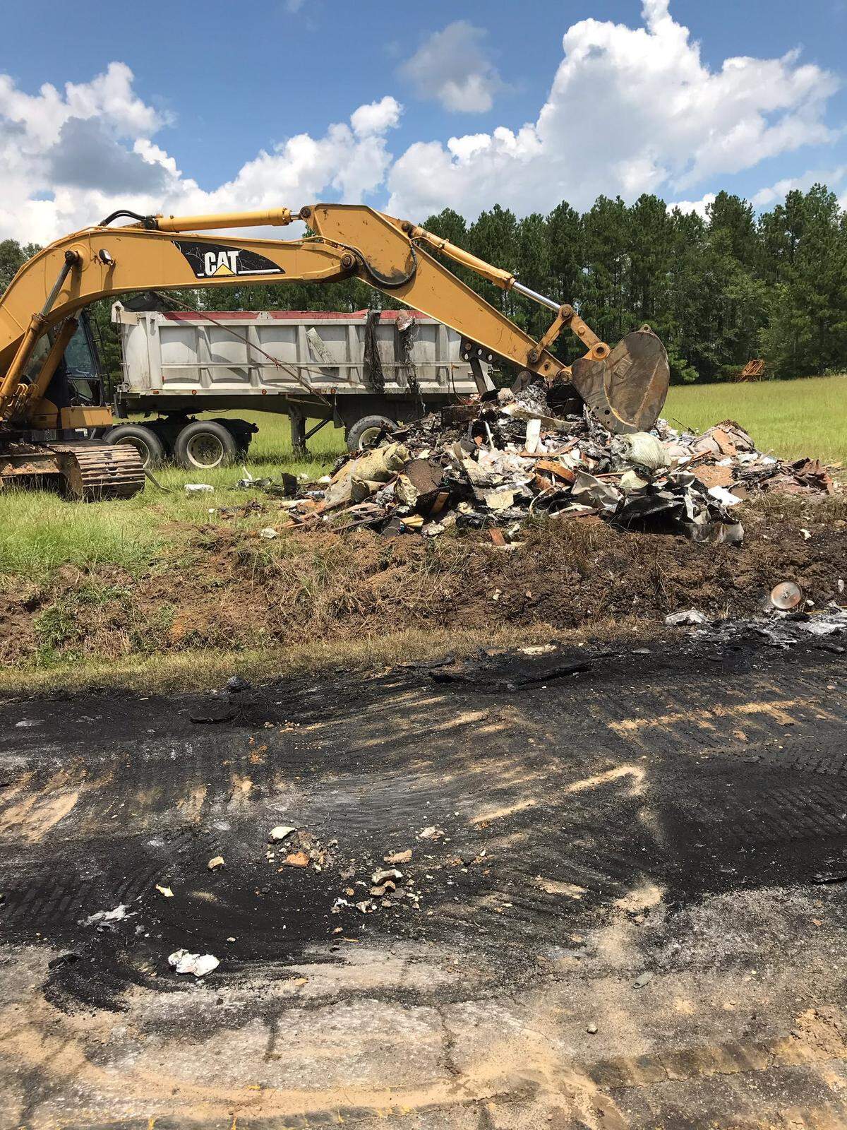 Local and state crews clean up a burned truck in Loris. 