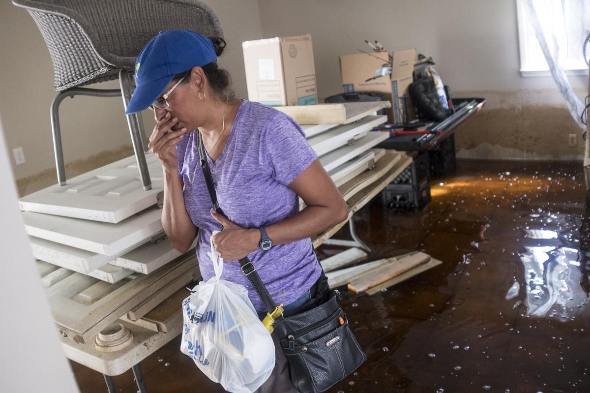 Suzy Centeno Hanson wades into her Rosewood home covering her nose to the throat-burning stench of the flood waters. While much of the Rosewood community in Socastee in still under water from Hurricane Florence’s flooding, a few residents were able to return to assess the damage and begin cleaning on Tuesday October 2, 2018.