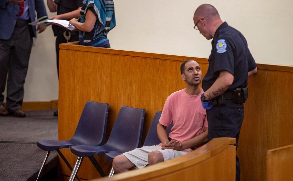 Adel Nassr Mansour, 47, speaks to a police officer inside the Myrtle Beach Police Department for a bond hearing on Thursday. Mansour was charged with third-degree assault and battery, Mansour’s trial was delayed until later in the month so that he can hire an attorney. Judge Jennifer Wilson set his bond at $776.