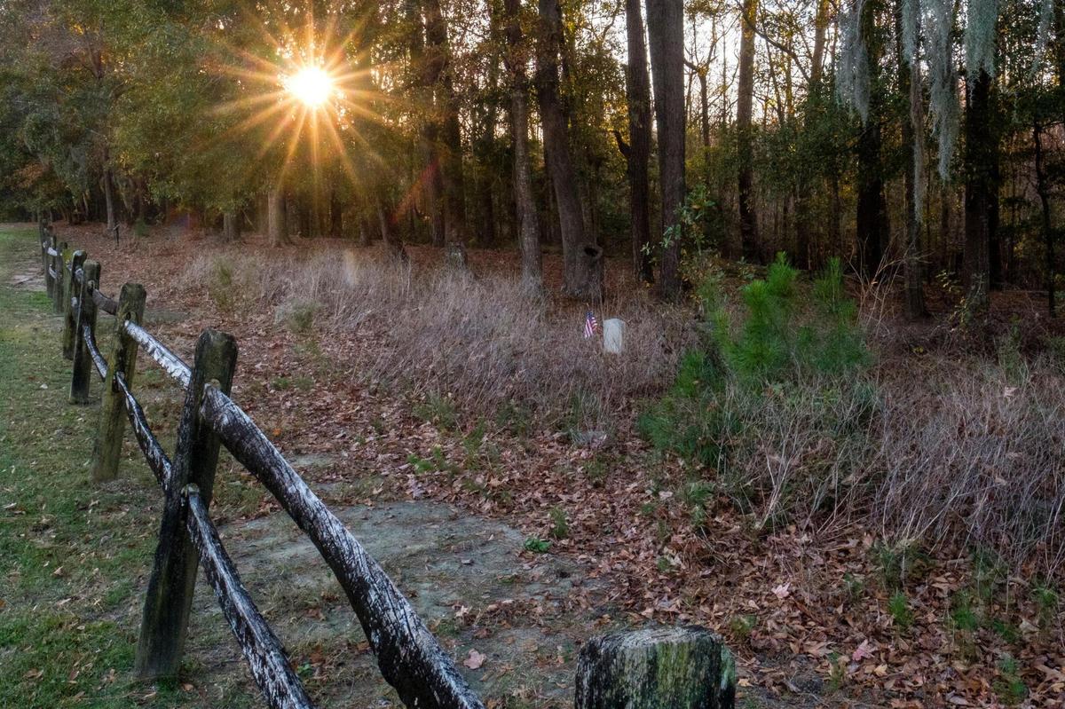 Graves, some marked and many more believed to be unmarked, lie in the swampy woods off the 13th fairway of Blackmoor Golf Course. Much of the Burgess and Freewoods areas were once home to slave plantations. Some local residents fear there could be more graves of former slaves throughout the area that may be disturbed by the continued growth. Dec. 15, 2021.