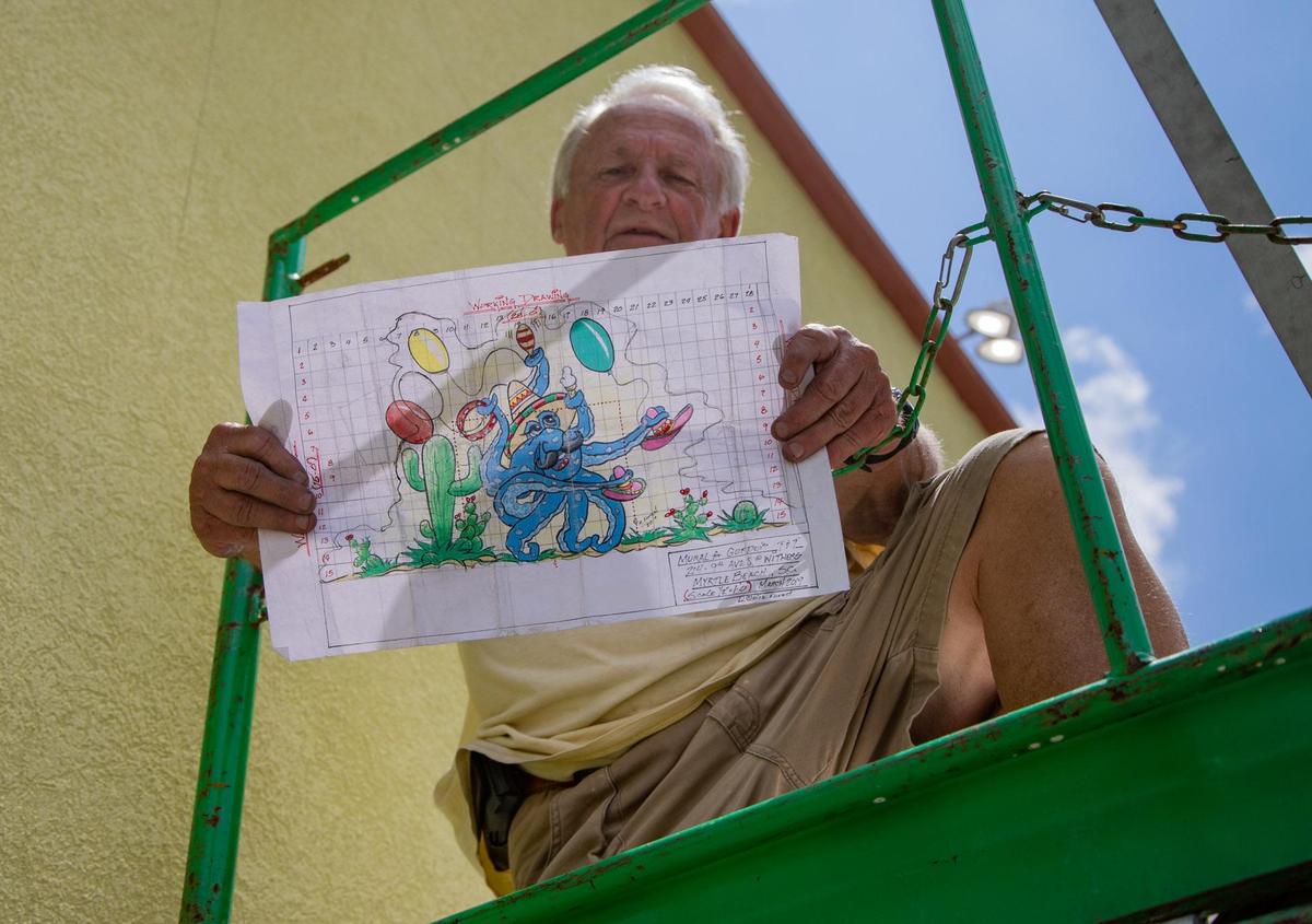Rick Forest of Little River holds up a sketch of a mural he will be painting on the side wall of Gordo’s Tacos & Tequila Monday afternoon in Myrtle Beach.
