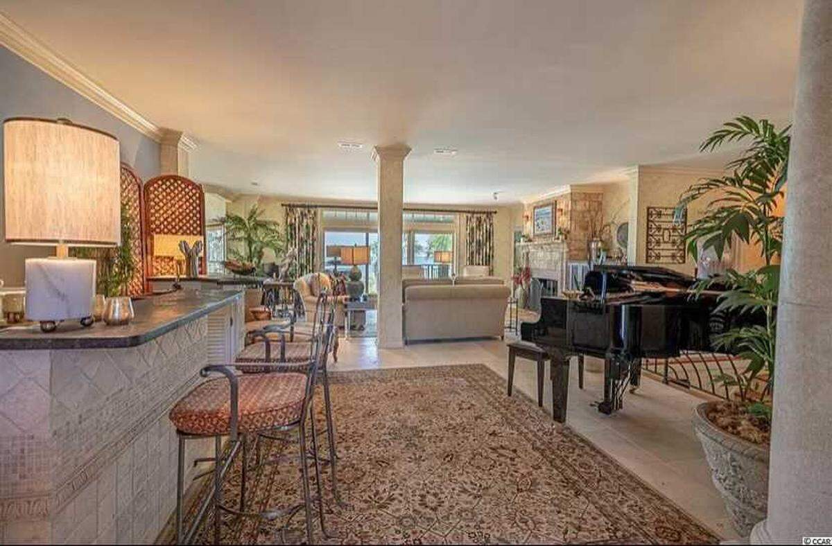 A gated beach house is for sale in Myrtle Beach on Ocean Boulevard for nearly $3 million. It has an oceanfront terrace, fitness room and two car garage.