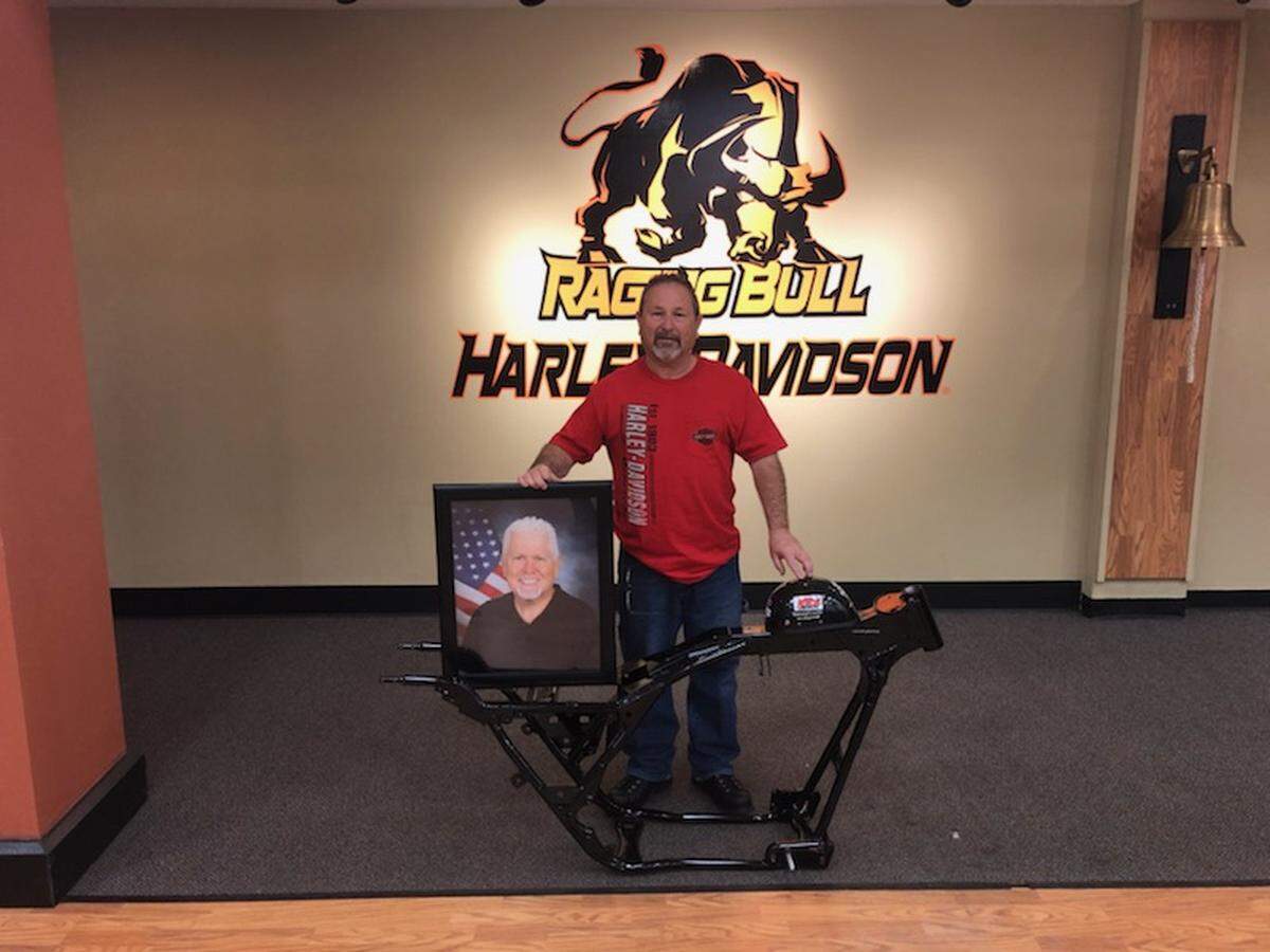 Thomas Lee Williams stands with the frame of a motorcycle he and Raging Bull Harley-Davidson are attempting to rebuild in honor of Sidney Williams (pictured), who died during the 2017 Myrtle Beach Fall Bike Rally