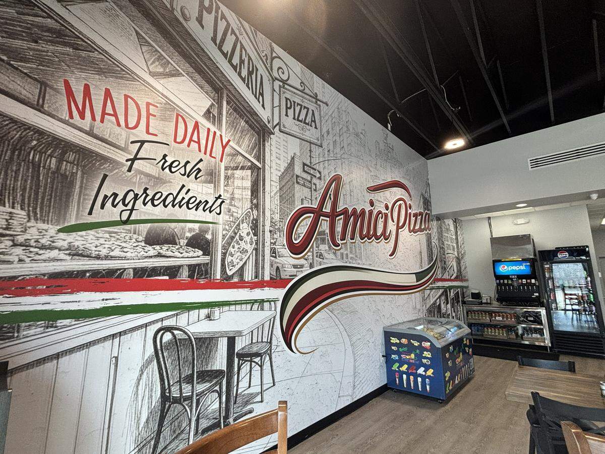 A mural of a typical block in New York covers a wall at Amici Pizza in Carolina Forest on May 13, 2026. The pizzeria opened on May 8.