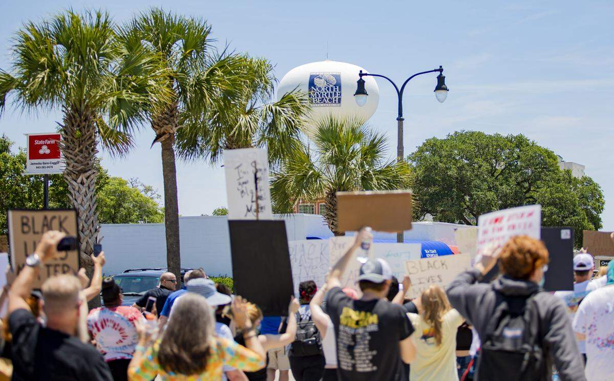 Protesters march along Main Street in North Myrtle Beach Tuesday afternoon to protest police brutality and the murder of George Floyd, who was killed by Minneapolis, Minn. police officer Derek Chauvin on May 25.