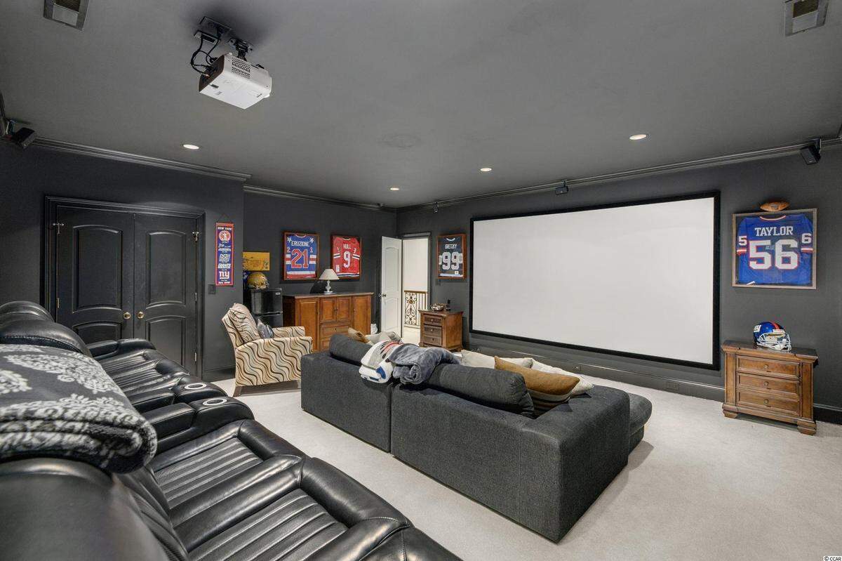 This 150-inch screen and home theater is a chief amenity of a $2.4 million home for sale in the Grande Dunes section of Myrtle Beach. The property was listed in October 2022.