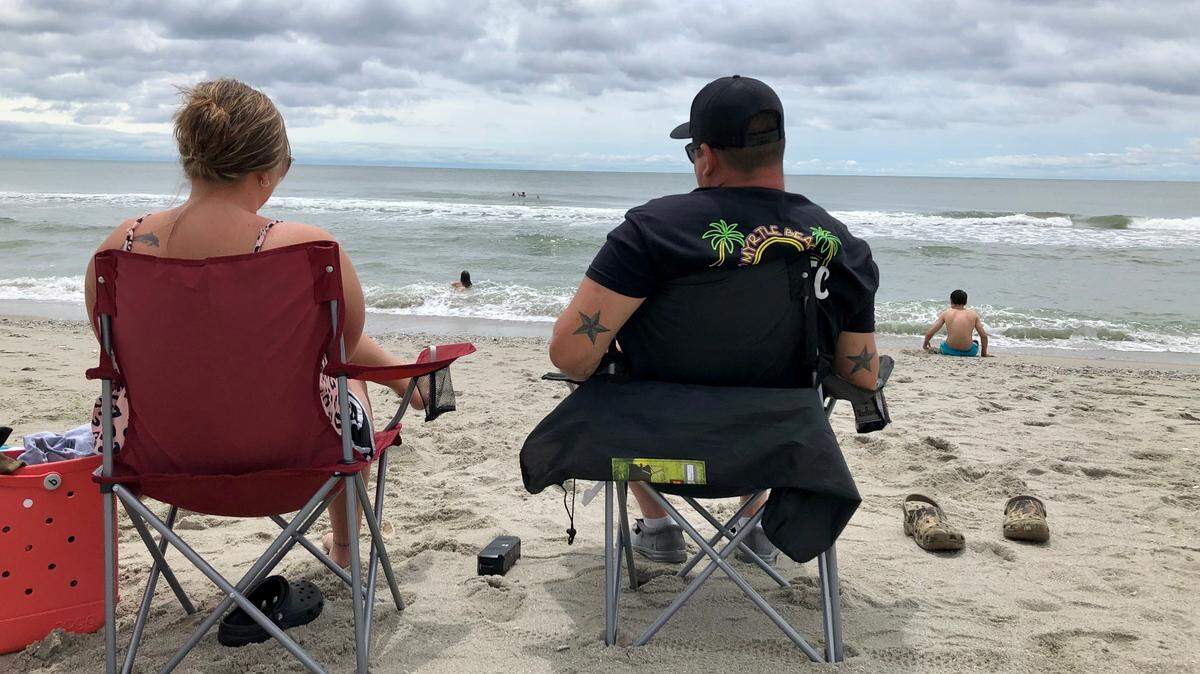Kristie Ludlum and Chris Perry of North Carolina sit near the 16th Avenue South beach access in Myrtle Beach. After a weekend of wet weather, people took to the beach on Memorial Day. May 29, 2023.