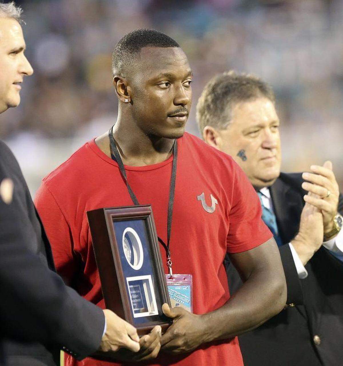 Former Coastal Carolina football star Lorenzo Taliaferro (center) is honored at halftime of the Chants’ game against South Carolina State in 2014.