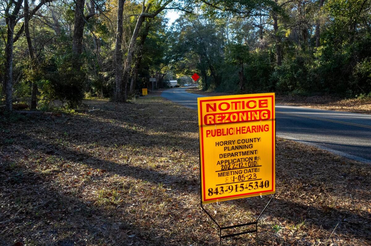 Signs announce a re-zoning request from ‘scenic and conservation’ to ‘suburban.’ The request would include about 25 acres of property owned by The Bluffs at Cherry Grove, LLC near the end of Little River Neck Road and close to Waties Island, S.C. The request was deferred by the Horry County Planning Commission on January 5, 2023.