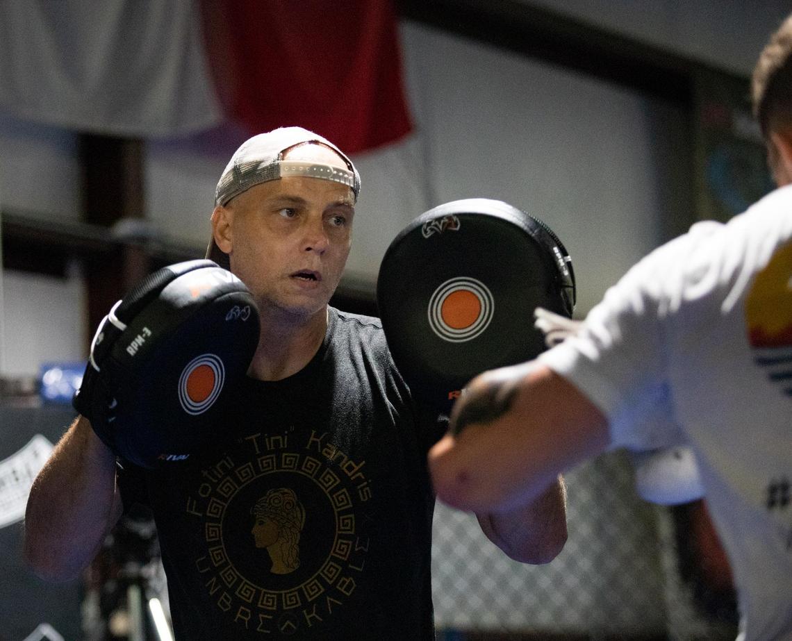 Trainer Chris Goude works with his fighter, Joe Solecki, Tuesday afternoon at Fitness Edge in Conway.