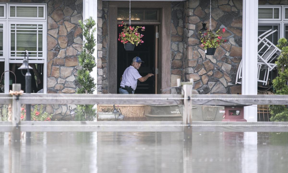 Lee Bertrand, gun strapped to his hip, is staying in his home off S.C.905 with his wife Fran and dog Dorothy. The Red Bluff community off S.C.905 has flooded along the Waccamaw River and Simpsons Creek under Hurricane Florence’s deluge with entire neighborhoods underwater. Monday, Sept. 24, 2018.