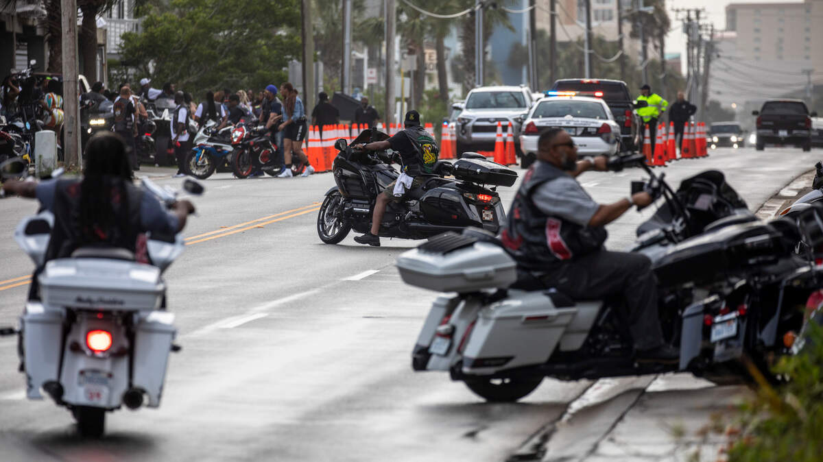 Bikers look for parking along Ocean Boulevard in North Myrtle Beach to attend a rainy day party in a parking garage on Friday afternoon as police direct traffic. The Atlantic Beach Bike Festival, aka “Black Bike Week,” returned on Friday after being canceled the last two years due to COVID-19. The event got off to a slow start in Atlantic Beach due to rain but parties were held in covered parking garages around North Myrtle Beach and as the rain cleared, the bikers returned. May 27, 2022.